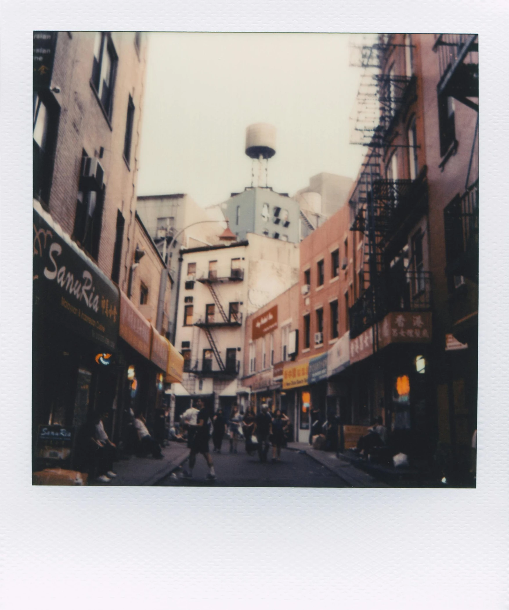 people walking and riding bicycles in an alley