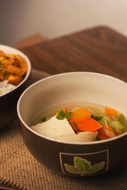 two bowls of food sit side by side on the table