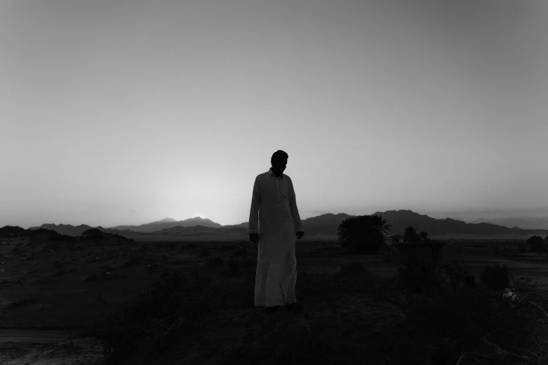 black and white po of a person in a desert area
