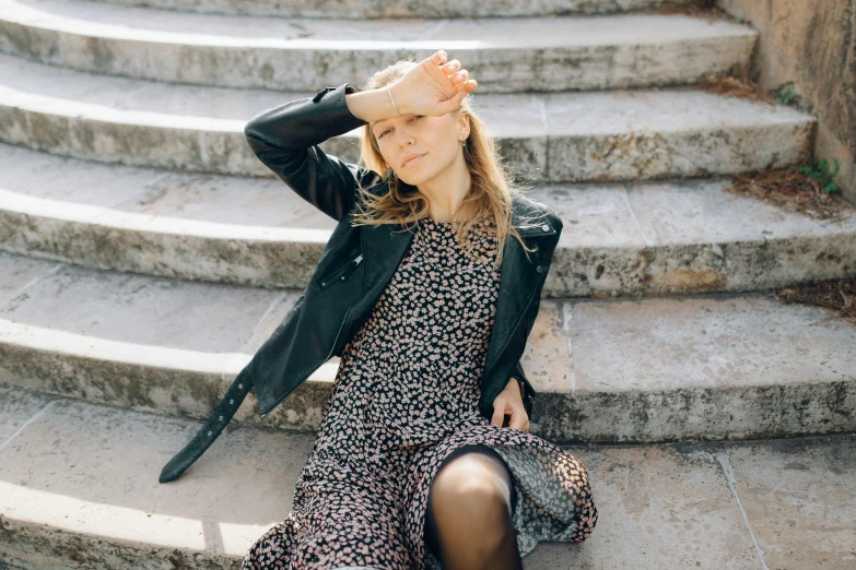 a woman is sitting down and posing