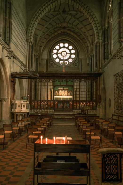 a small church filled with wooden benches next to stained glass windows