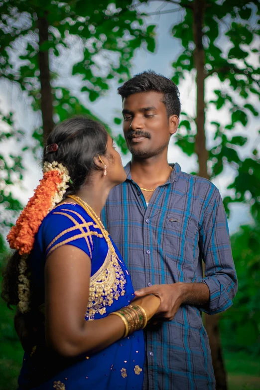 an indian couple posing for their wedding pos