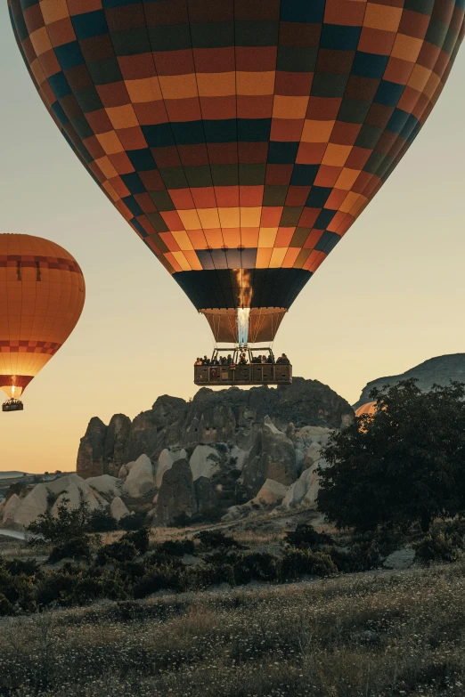 a couple of large  air balloons that are in the sky