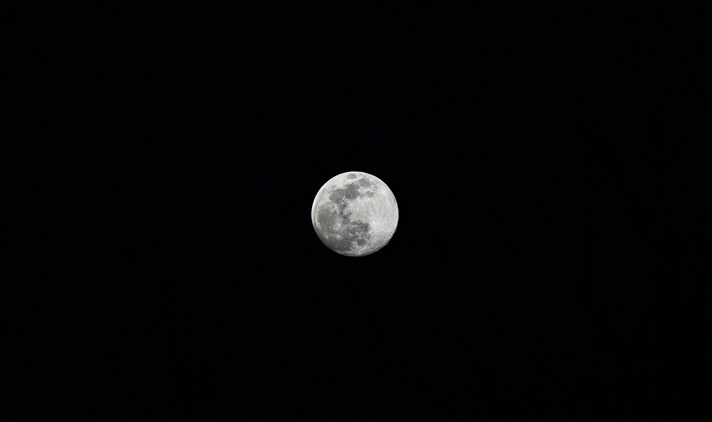 a full moon with no clouds in the sky