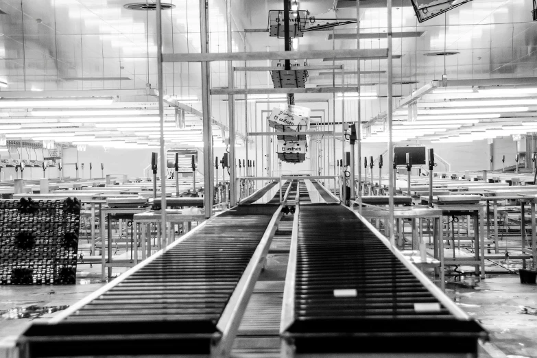 a factory floor with a conveyor belt and tables