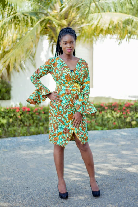 the girl poses outside in her colorful printed dress