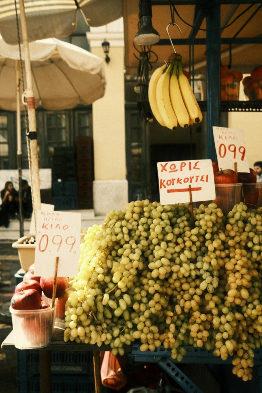 fruit is displayed at an open market on the street