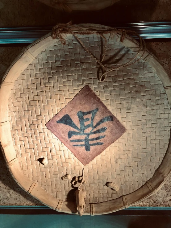 a decorative wall hanging decorated with an abstract symbol