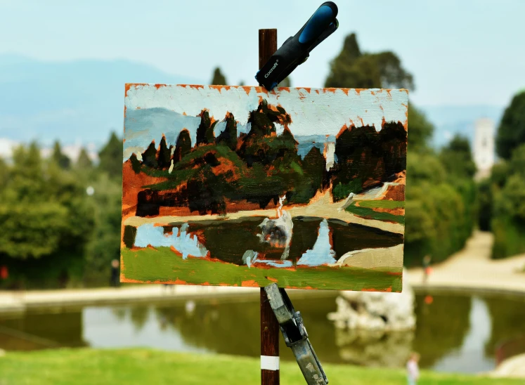 a painting being painted on the side of a wooden stick