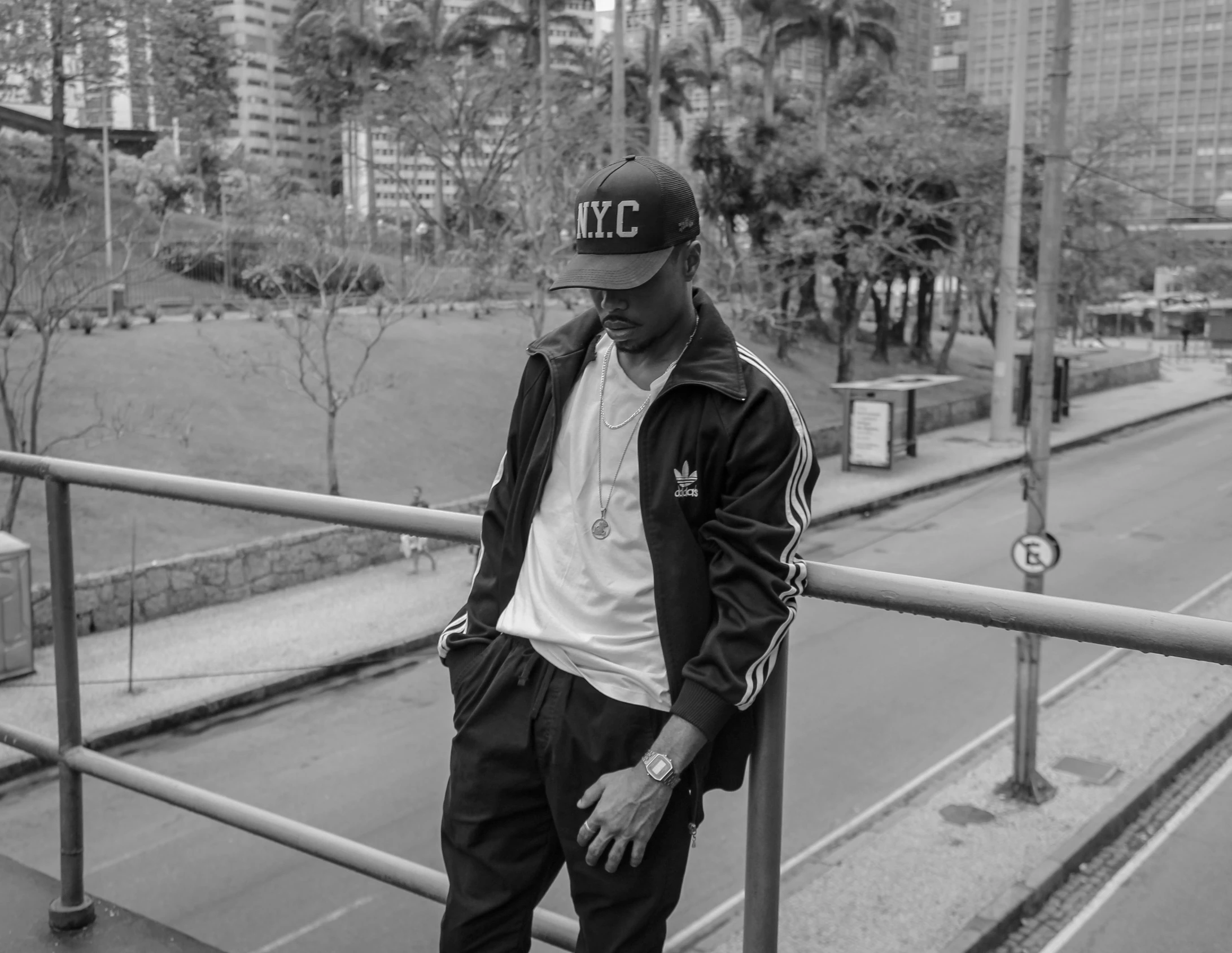 a young man is posing at the fence