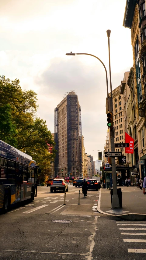 cars and buses are driving down the street