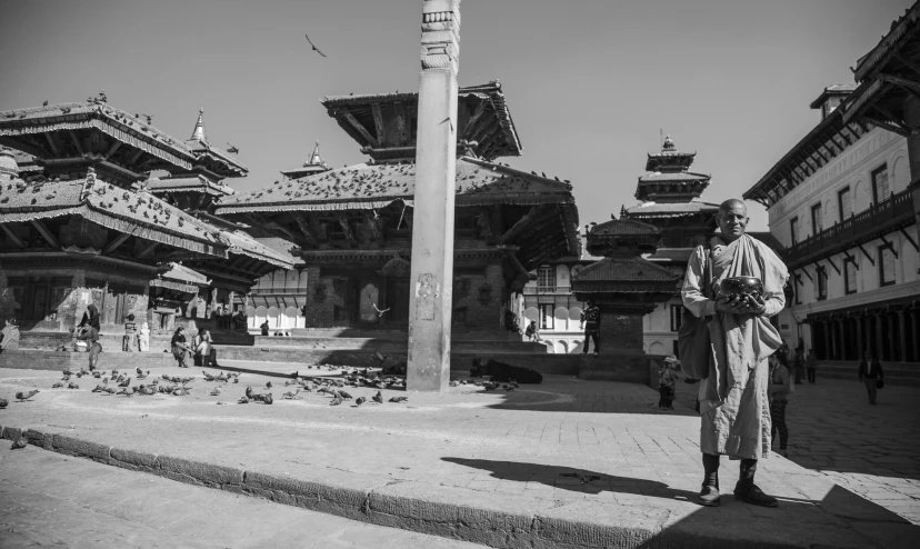 a man standing next to two tall building