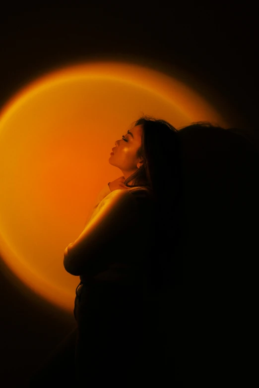 a woman standing next to an orange ball