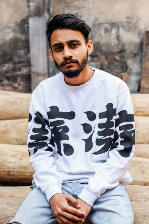 a man in white shirt with asian writing on it