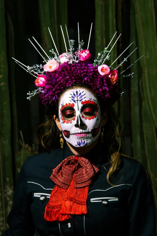 the woman with a skull face paint in a mexican day of the dead costume