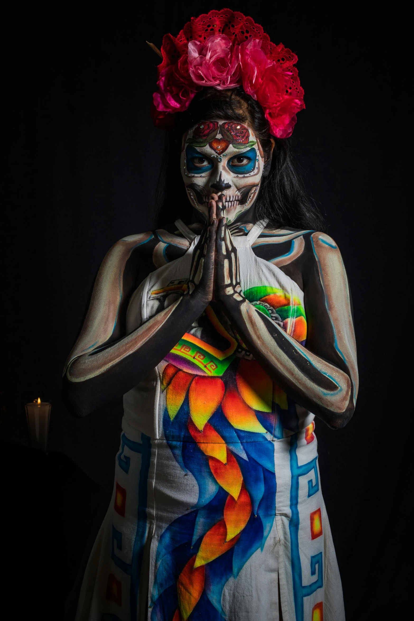 a woman with painted body paint is holding up a knife