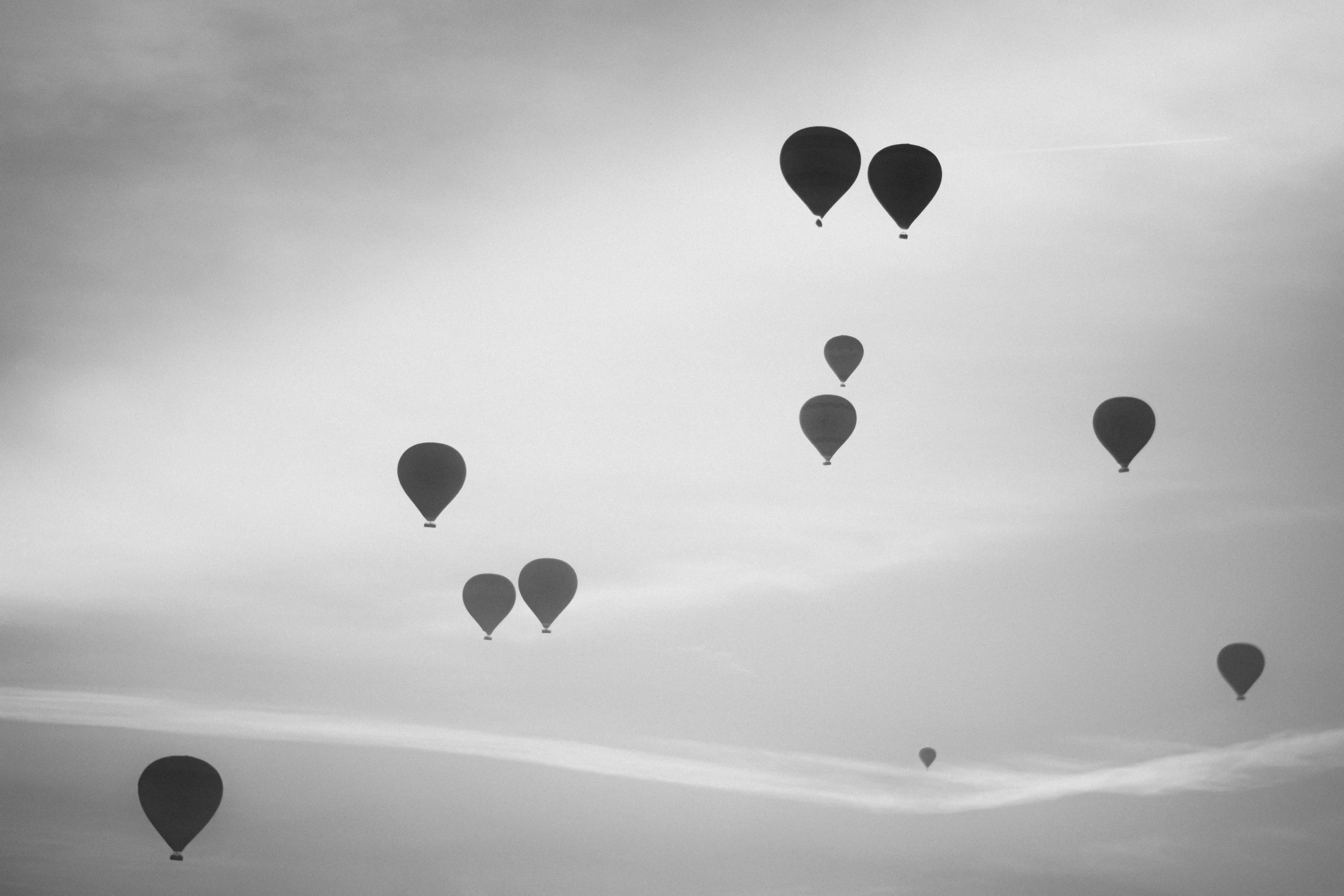  air balloons flying in the sky over head