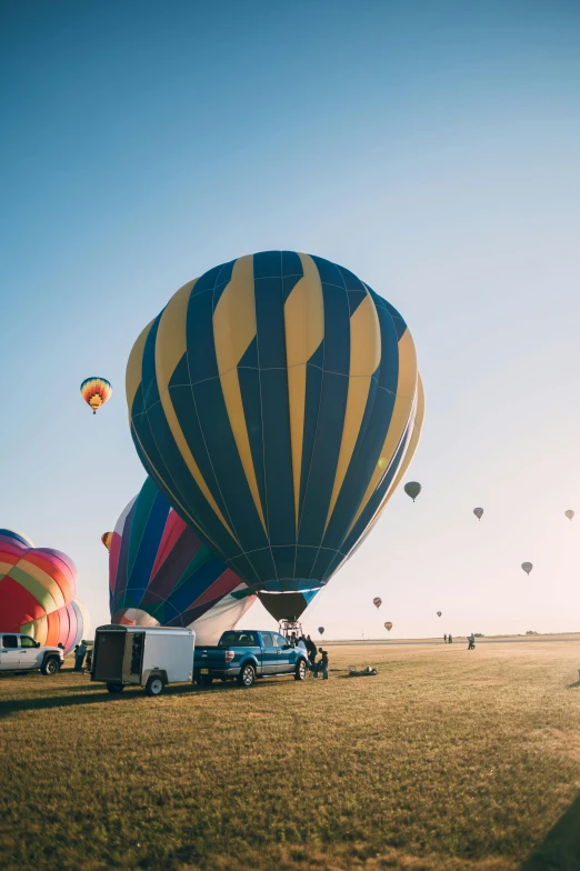 colorful  air balloons floating over a green field