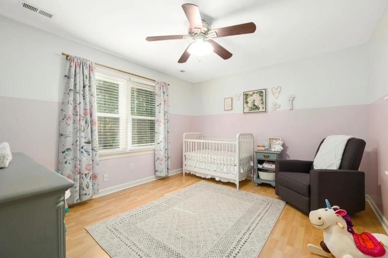 a nursery with pink walls and lots of curtains