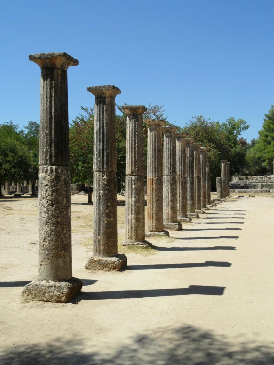 ancient roman ruins are lined up on dirt