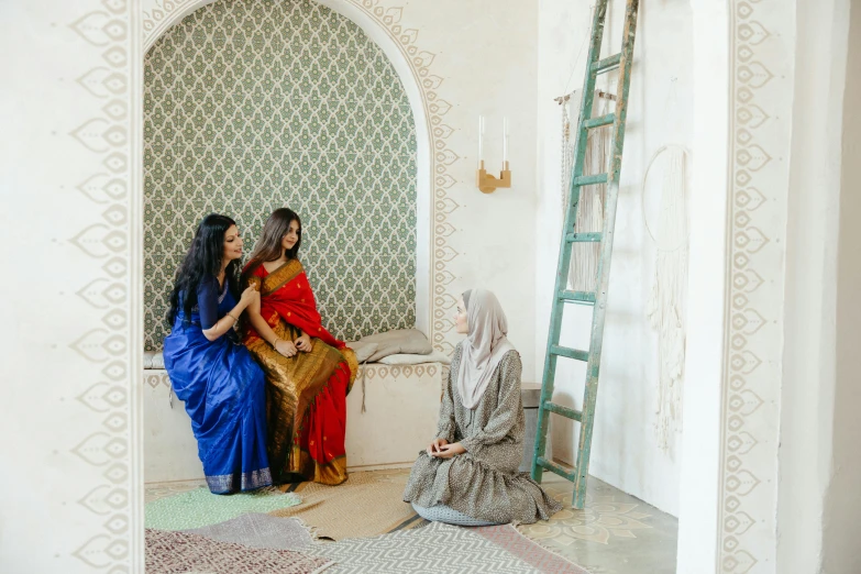 two women sitting and standing near one another