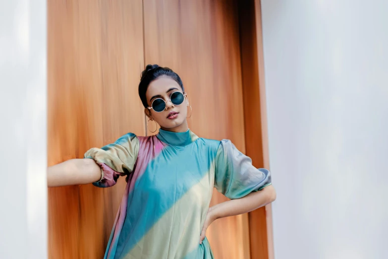 a young woman posing with her hands on her hip and arm around her waist