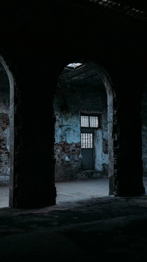 a view into an old warehouse with a large archway