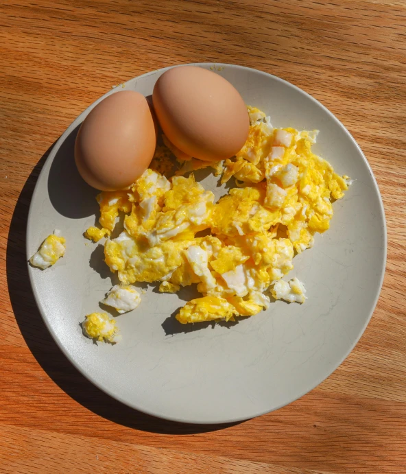 a white plate topped with two eggs and other items