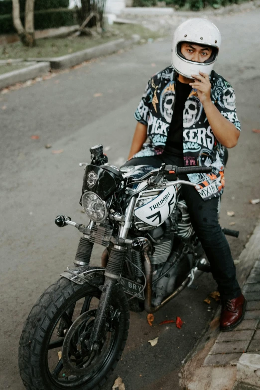 the man is sitting on a motorcycle with no helmet