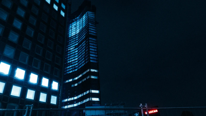 a large building with two levels and a neon sign