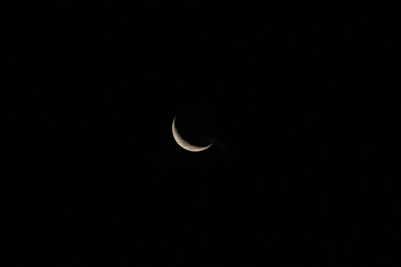 a crescent on a black sky at night