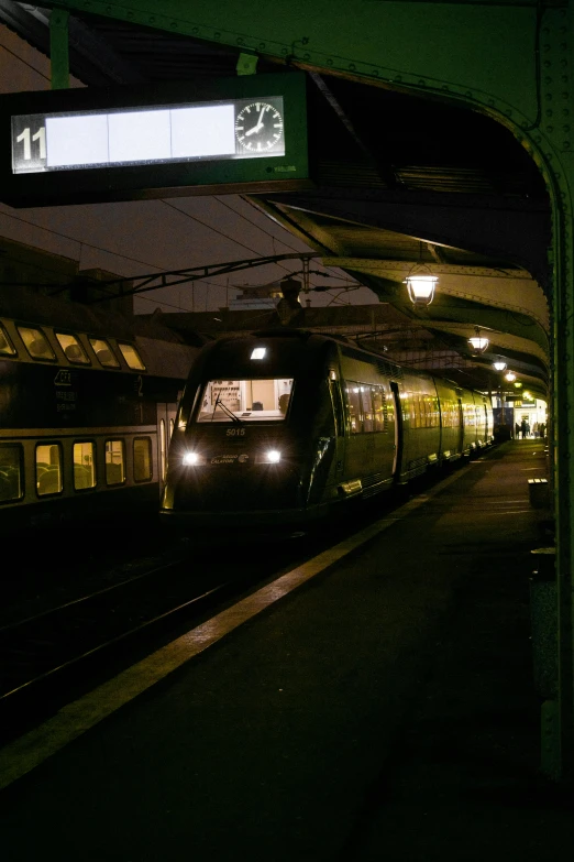 a black train at night on some tracks