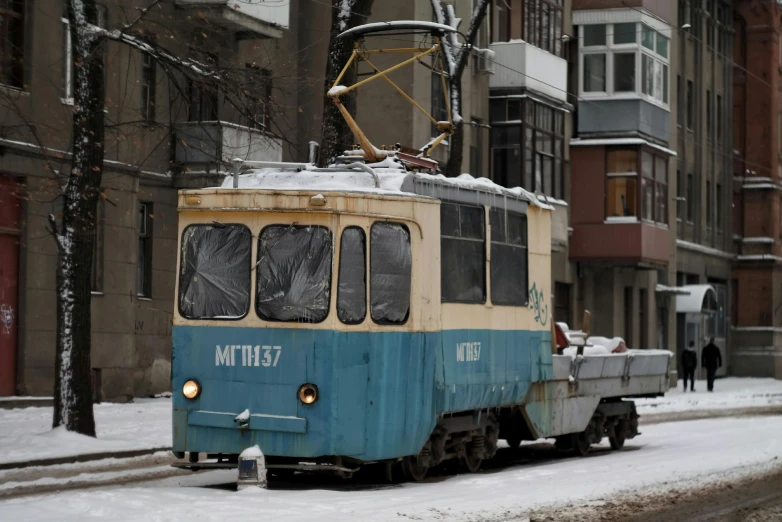 a cable car in the middle of a snowy street