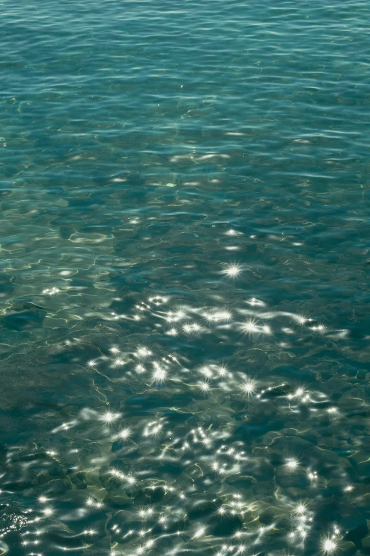 an airplane flies over the crystal waters of the ocean