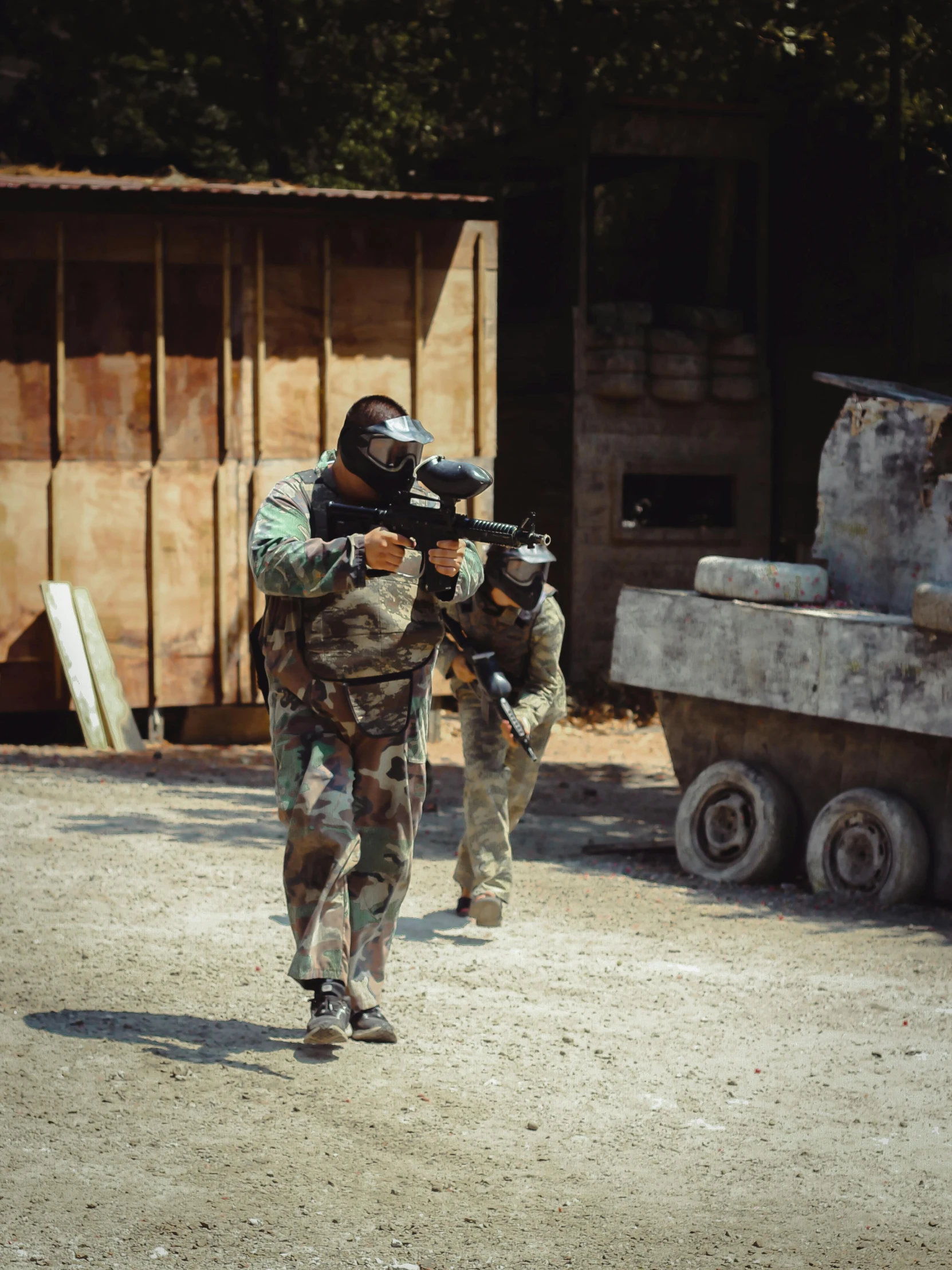 two men dressed in camouflage and holding weapon during a game