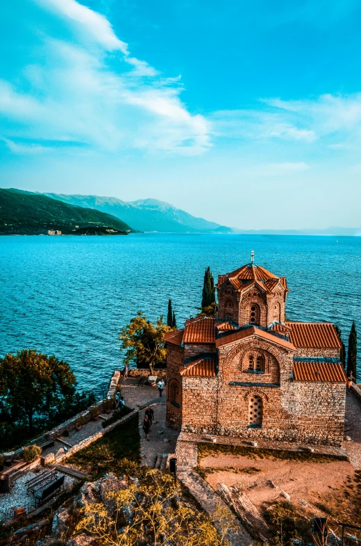 a small church by the water's edge during the day