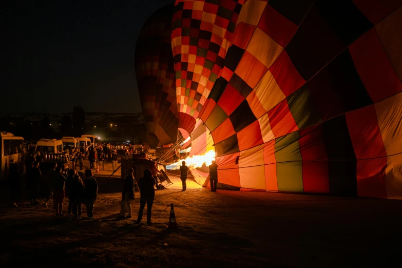 a group of people standing around a big balloon