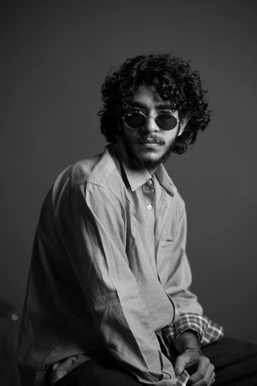 a black and white po of a man with curly hair