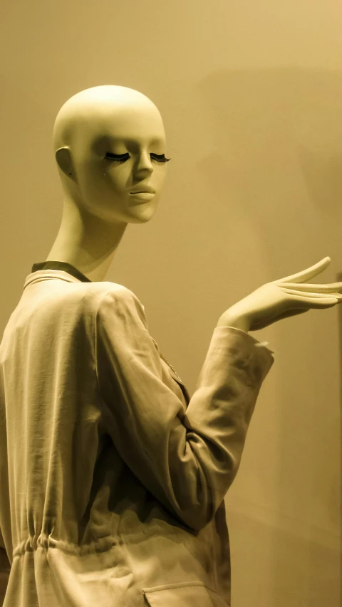 a person's white mannequin with one arm outstretched in front of it