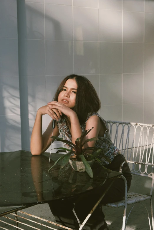 a woman sitting at a table with her arms crossed