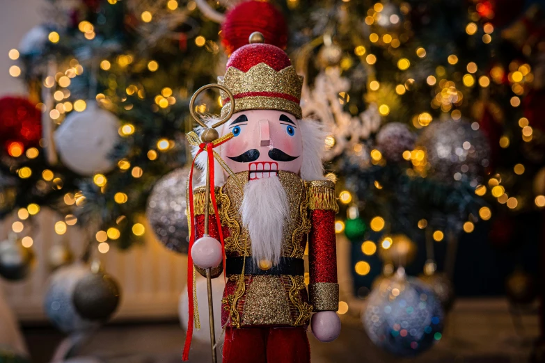 a nuter is standing in front of the christmas tree