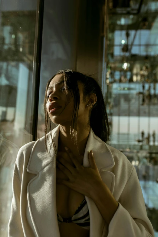 a woman looking in a bathroom mirror, getting dressed up