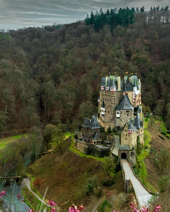 an old castle surrounded by trees and flowers