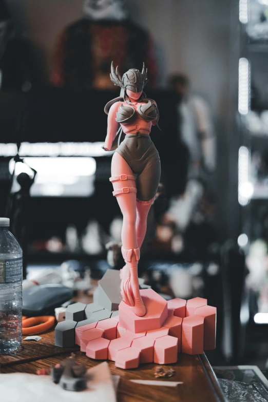 the figurine stands on a table in the studio