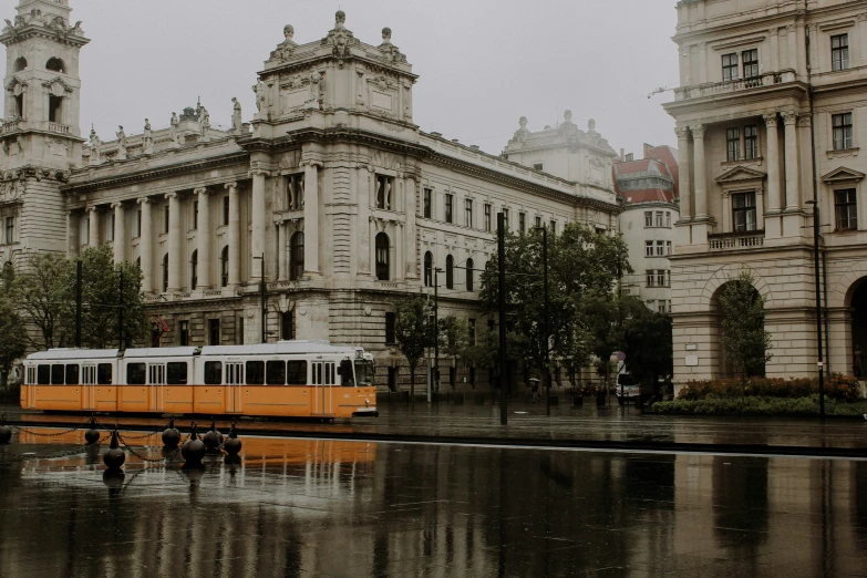 a train traveling past a group of older buildings