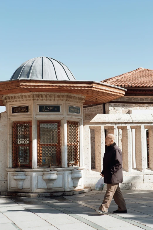 the man is walking in front of a building