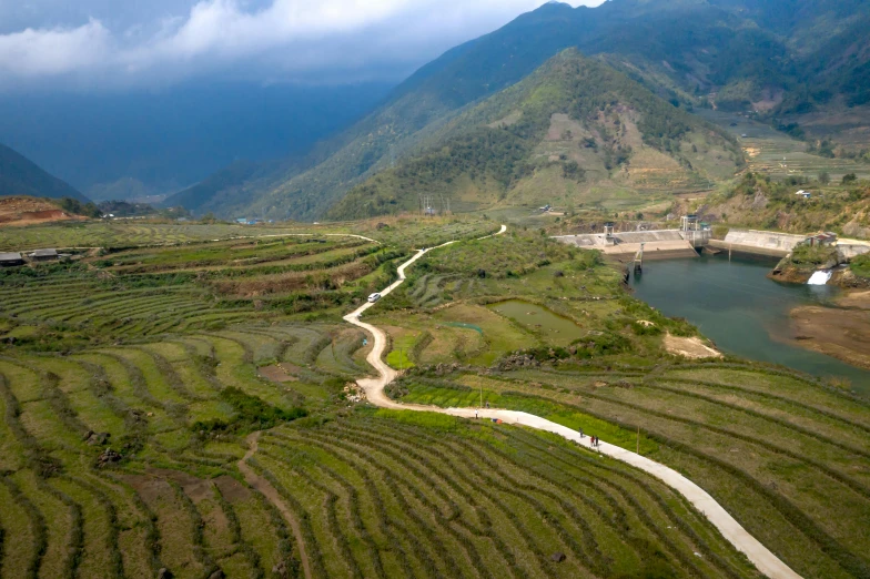 the view of an area in the countryside where there are water, fields and houses