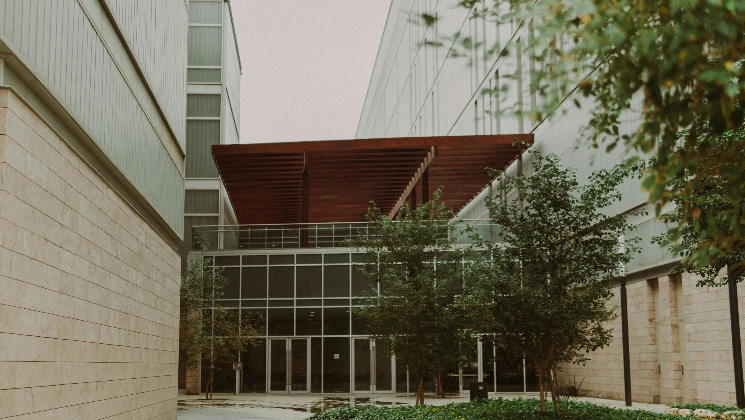 a large building next to some small trees