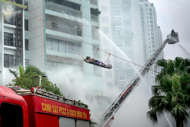 a fire truck being pulled by a helicopter