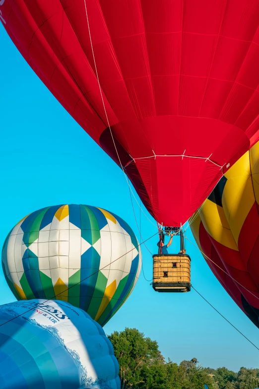 the  air balloons are being lifted by a rope